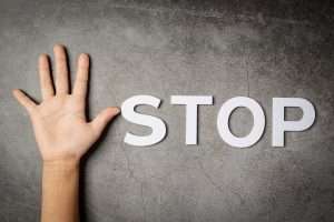 word stop with child s hand dark wall